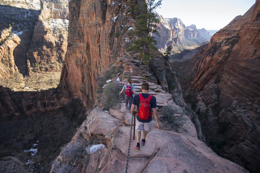A man and woman hiking Angels Landing in Zion national Park.