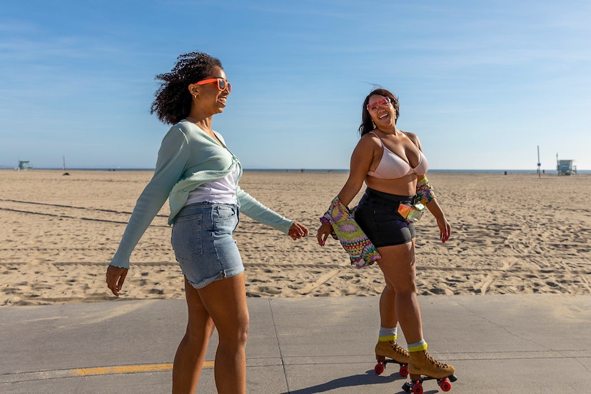 Friends rollerskating along the beach in Los Angeles.